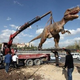 Illustration for article titled Whats Better Than A Giant Gundam Statue? A Dinosaur, Apparently.